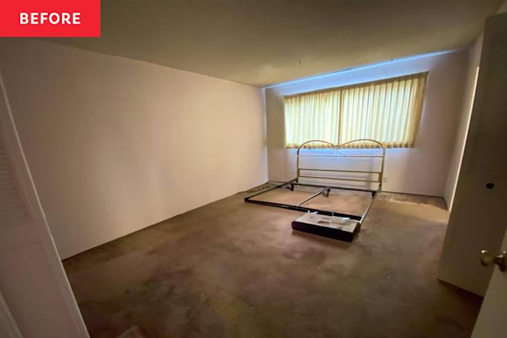 Bed frame in carpeted bedroom before renovation.
