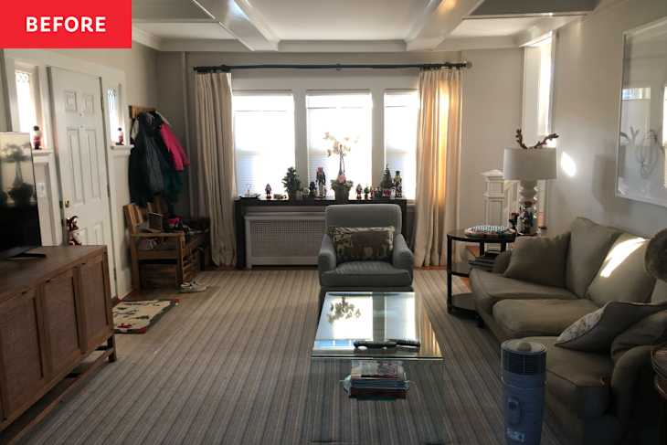 Living room with a gray armchair, beige sofa, glass coffee table, and decorative items on windowsill.