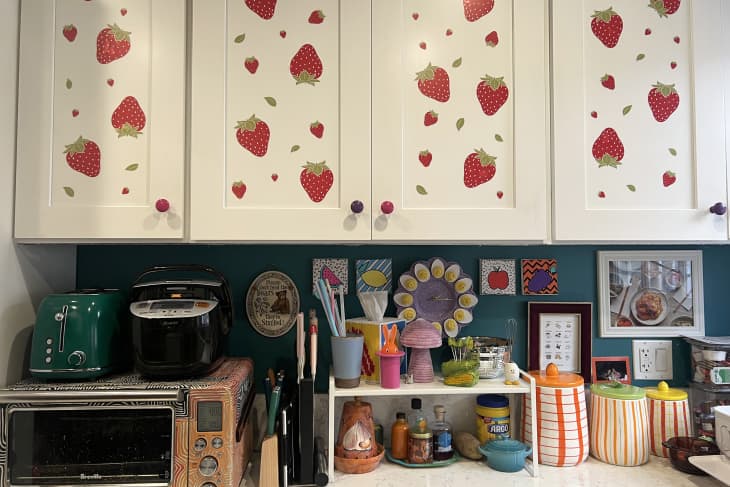 White kitchen cabinets with renter-friendly strawberry decals