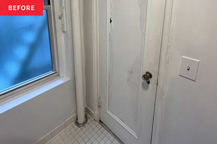 White bathroom door before applying graphic wallpaper.