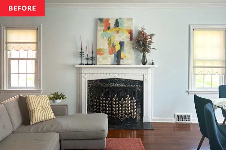 Living room with a gray sectional sofa, colorful abstract art above a white mantel, and decorative candles.