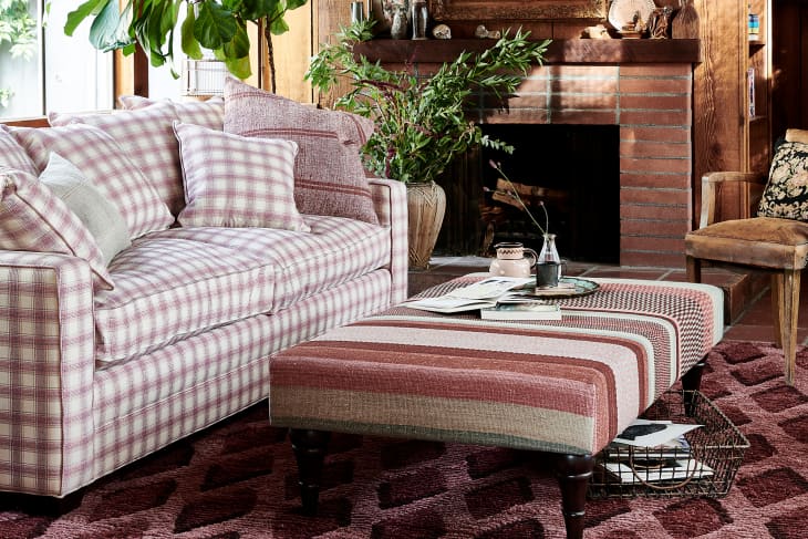 GreenRow's pink plaid sofa next to pink upholstered ottoman