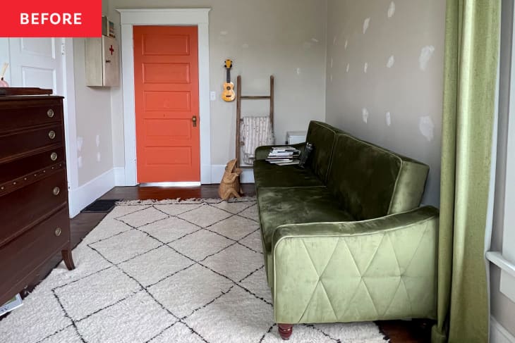 Green sofa and curtains and dark wood dresser in neutral room with shag rug and brightly painted door.