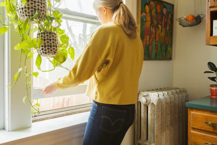 Woman opening a kitchen window