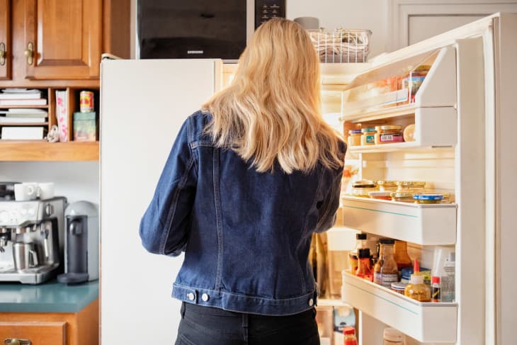 Someone looking inside refrigerator.