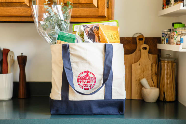 Canvas bag filled with Trader Joe's groceries on countertop.
