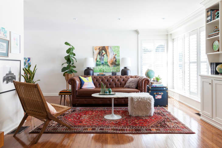 Living room with a leather sofa and large vintage area rug