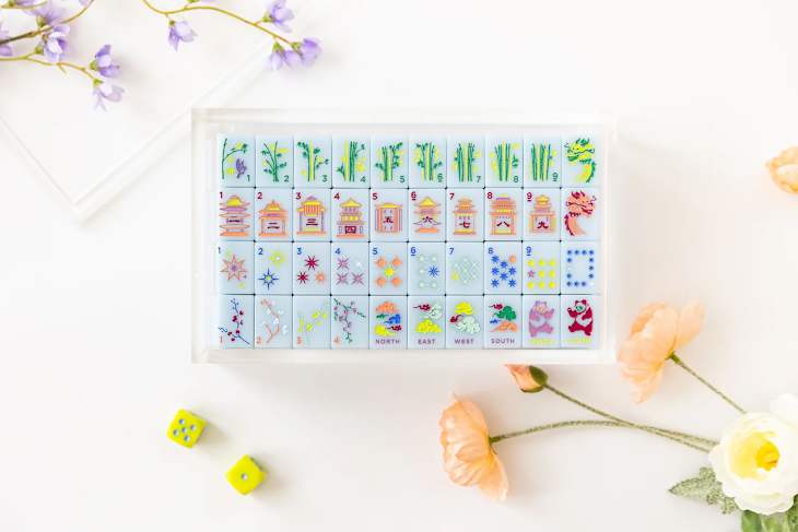 Bam bird mahjong set with flowers around.