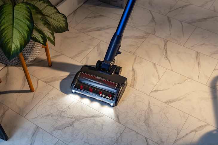 Someone vacuuming floor.