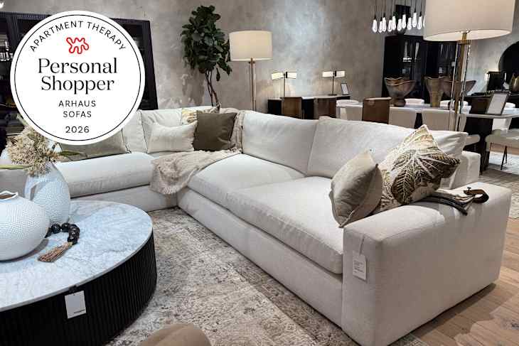 L-shaped cream sectional sofa with decorative pillows, a round marble coffee table, and a textured area rug.