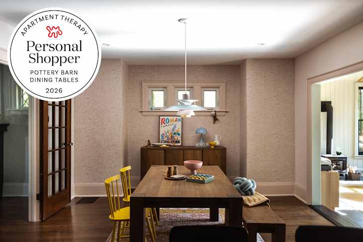 blush wallpapered dining room with wood dining table and yellow chairs