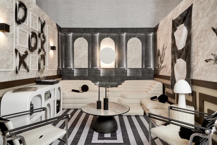 black and white room with futuristic furniture and decor, tic tac toe spay paint on wall