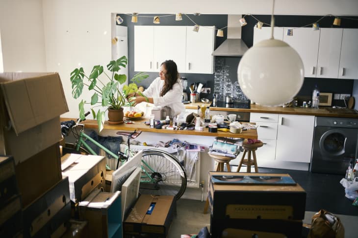 Woman watering her plants in the process of moving house