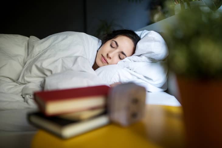 Young woman sleeping peacefully on her bed at home.