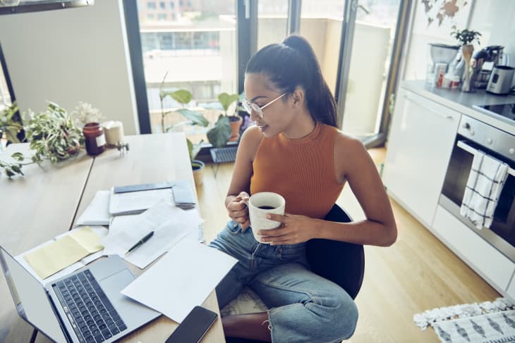 Positive japanese woman freelancer working from home, using