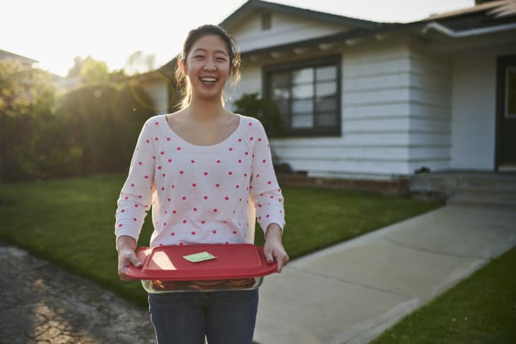 Woman delivering homemade cookies to neighbor