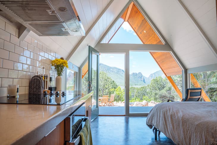 At 400 square feet of polished concrete floor, this triangle-shaped tiny house in Colorado is the perfect unique vacation rental getaway for travelers. The coded door makes it easy for guests to enter and exit as they please.Colorado's Thimble Rock Point, Cliffs in Unaweep Canyon is visible out the front glass window from the master bedroom.