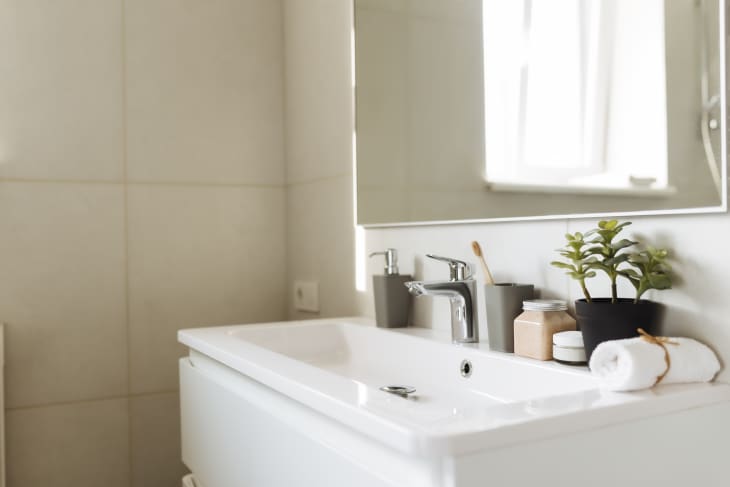 Wash basin In White Bathroom With Bath Accessories