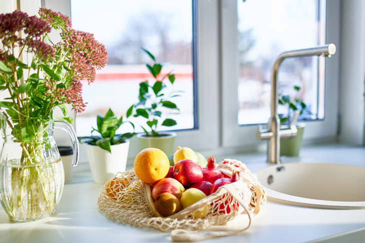 Fruits in reusable bag on kitchen counter in home