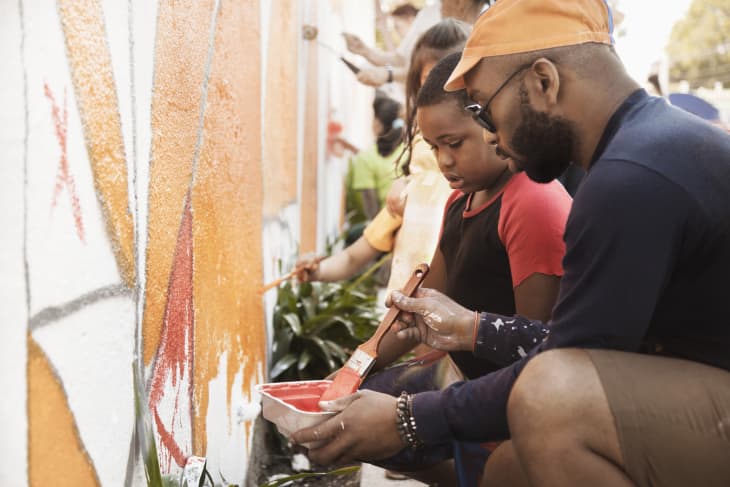 People painting wall together