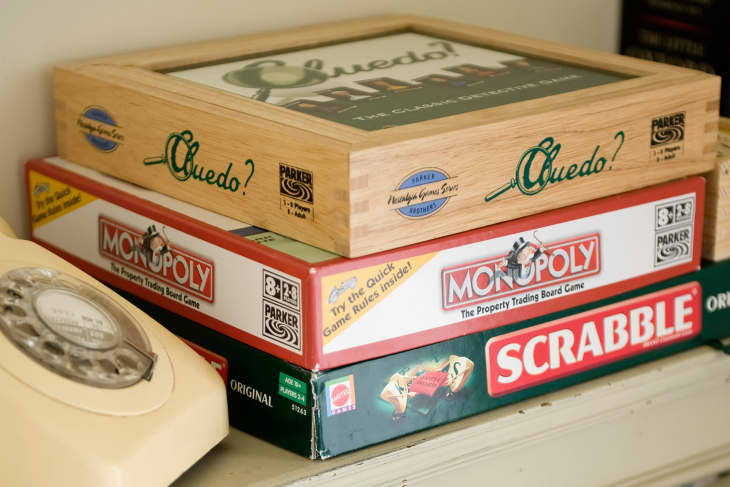 Stack of boardgames on bookshelf