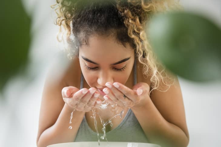 Person splashing water on face