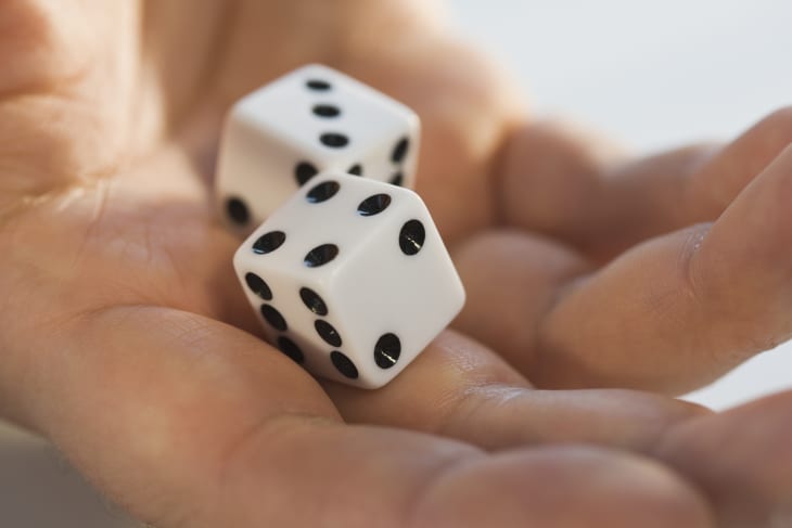 Close up of dice in man's hand