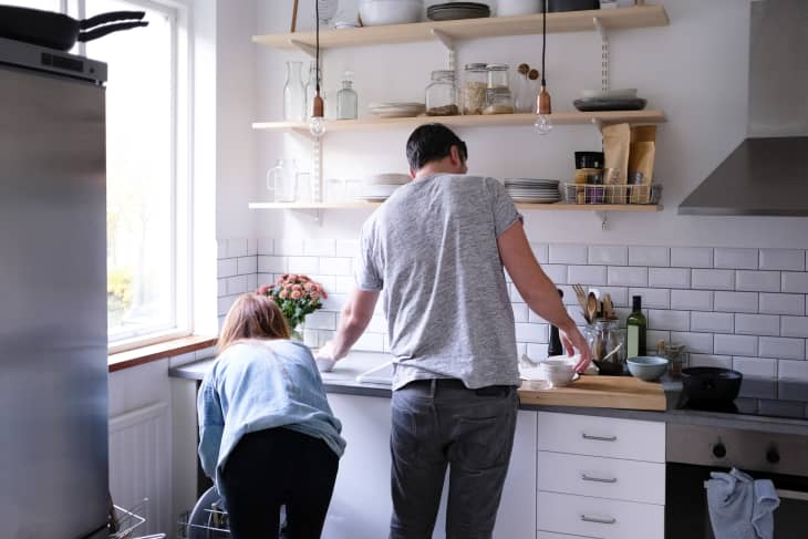 ear view of couple working in kitchen at home.