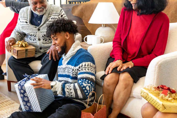Family opening christmas gifts together
