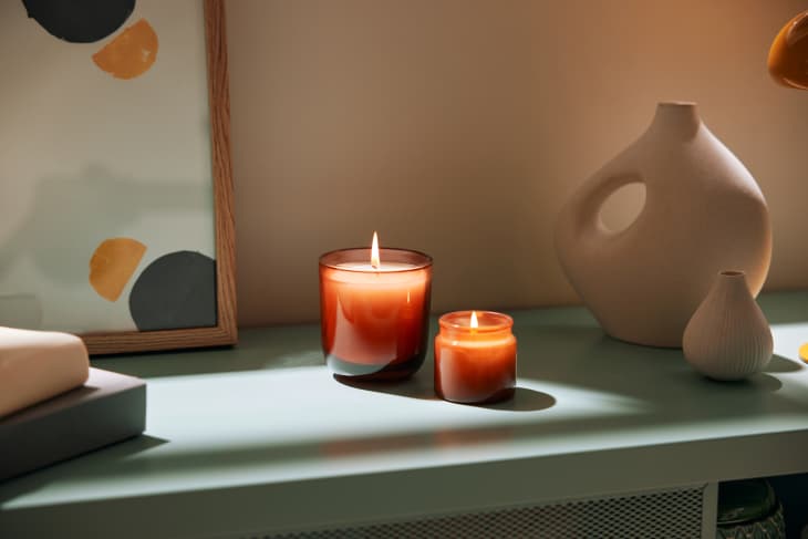 Burning candles near modern decorations