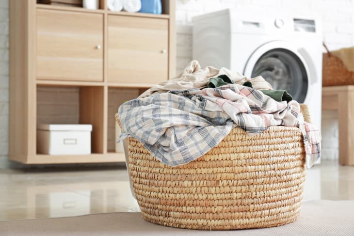 Basket with dirty laundry on floor in bathroom