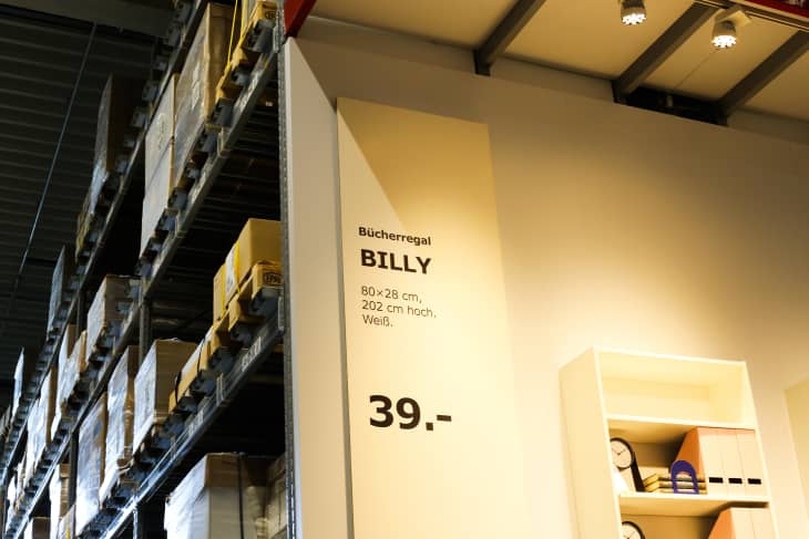 Kaarst, Germany - November 16. 2019: View on aisle with high metal shelves in self service storage of Swedish furniture store IKEA. Shelf contains famous bookshelf BILLY.