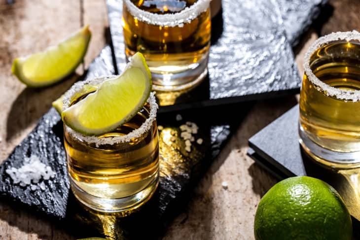 Mexican tequila with lime and salt on black background.