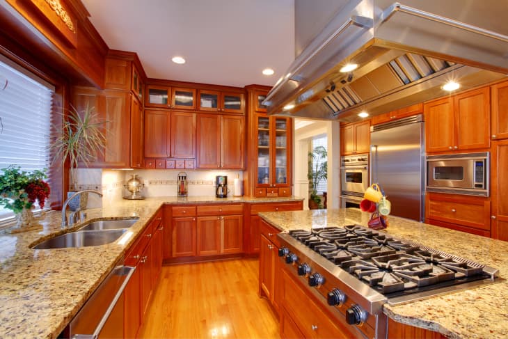 wood cabinets kitchen interior. View of storage combination, kitchen island and appliances