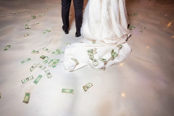 Bride and groom first dance. Money is on a floor as part of the wedding tradition.