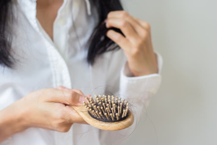 Closeup of comb brush with long loss hair with copy space-Healthcare concept.