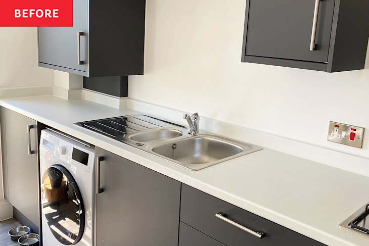 Modern kitchen with gray cabinets, stainless steel sink, and a washing machine under the counter.