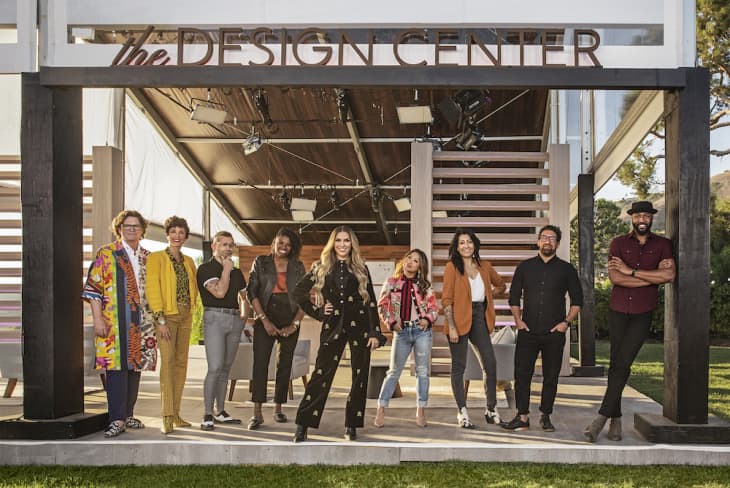 Nine people standing in front of a building labeled "The Design Center," showcasing diverse styles.