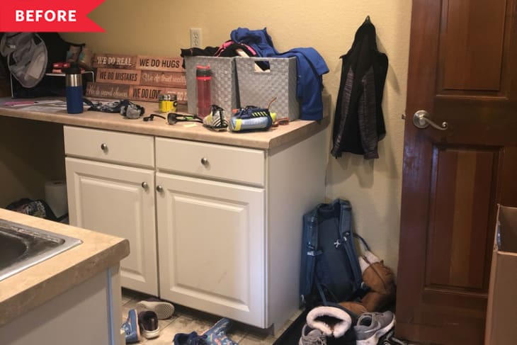 Cluttered mudroom with white cabinets, shoes, bags, and assorted items on the counter and floor.