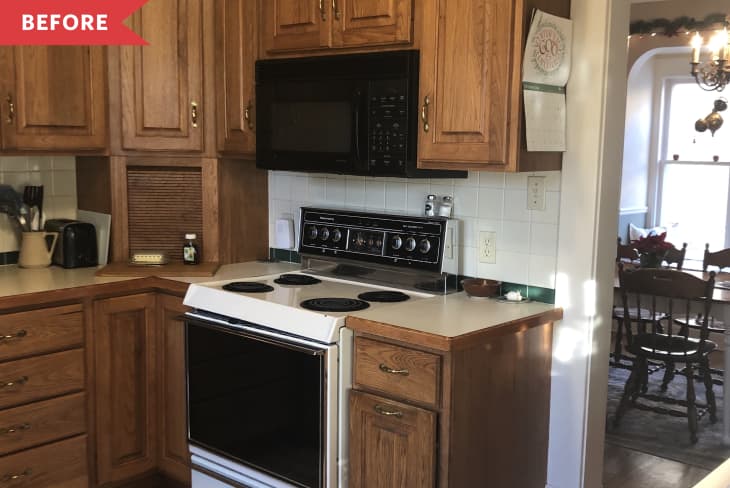 Before: Brown wood kitchen cabinets with dated range