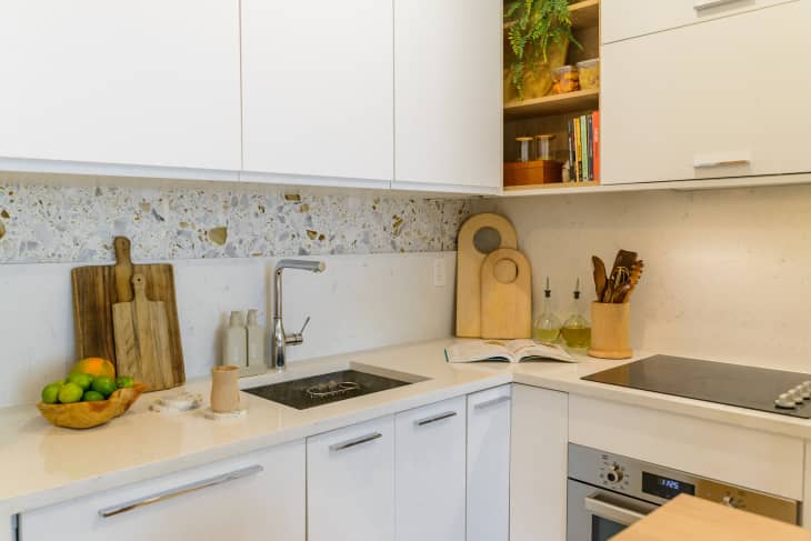 white kitchen with white cabinets and terazzo backsplash