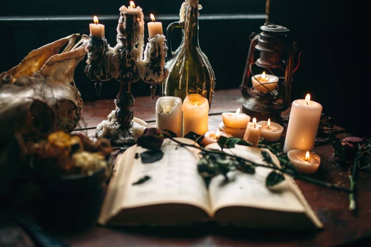 Witchcraft, dark magic, candles with ritual book
