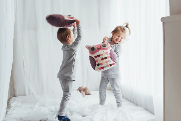 Children in pajamas playing in bed