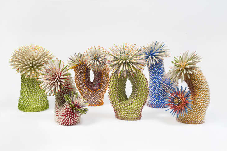 Colorful abstract sculptures with spiky textures in green, blue, and orange hues, resembling sea anemones.