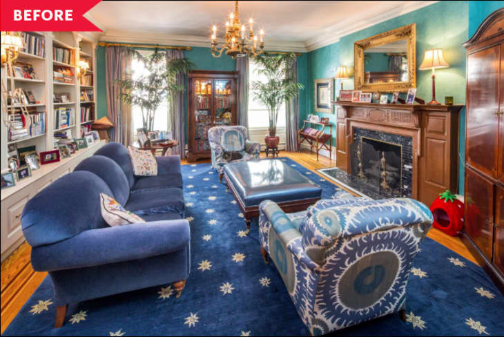 Before: Living room with turquoise venetian walls, built-in shelving, and blue furniture