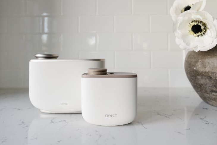 two white oil diffusers on a white counter