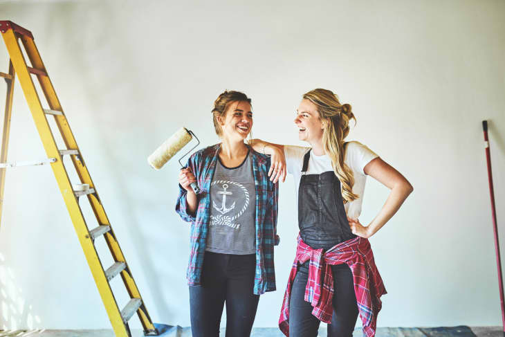 two young woman busy with renovations at home