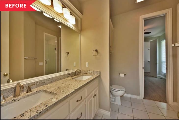 Bathroom with double sink vanity, granite countertop, large mirror, and toilet, leading to a carpeted room.