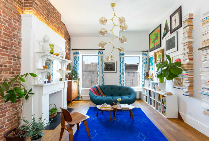 Living room in Park Slope condo with blue rug and blue love seat.
