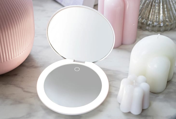 Compact light store up mirror